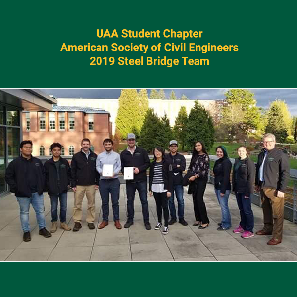 Picture of the 2019 UAA Steel Bridge Team standing in a line with their awards.