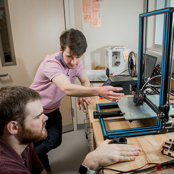 UAA Robotics Club members use a 3D printer to fabricate parts for the team’s new rover in the robotics lab in UAA’s Engineering and Industry Building