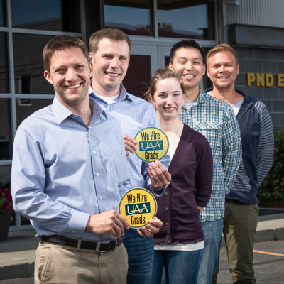 PND Engineers stand with "we hire uaa grads" stickers.