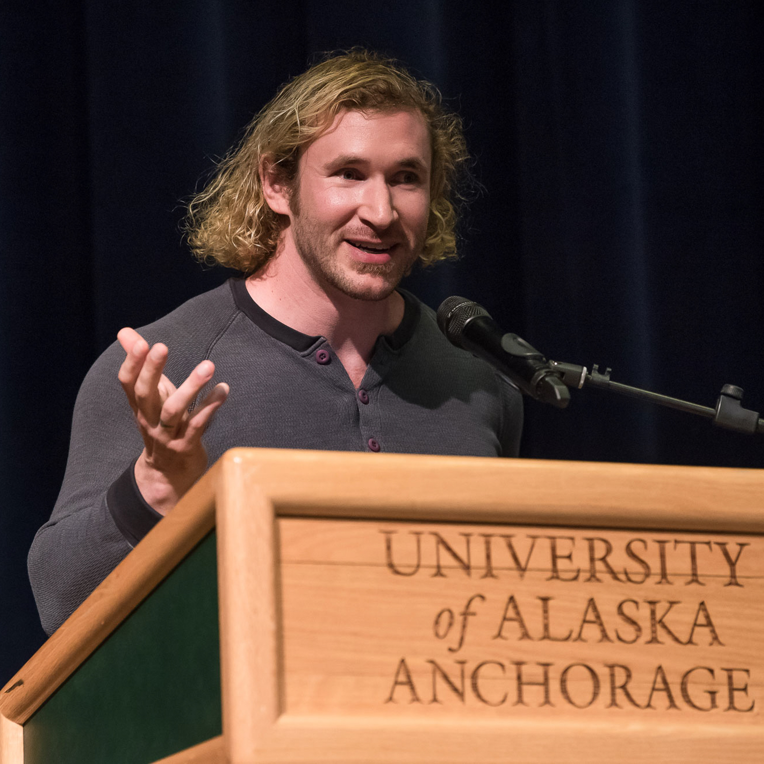 Nick Armstrong stand at a University of Alaska Anchorage podium.