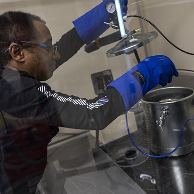 Dr. Hailu attaches a resevoir of liquid nitrogen to a spray nozel.