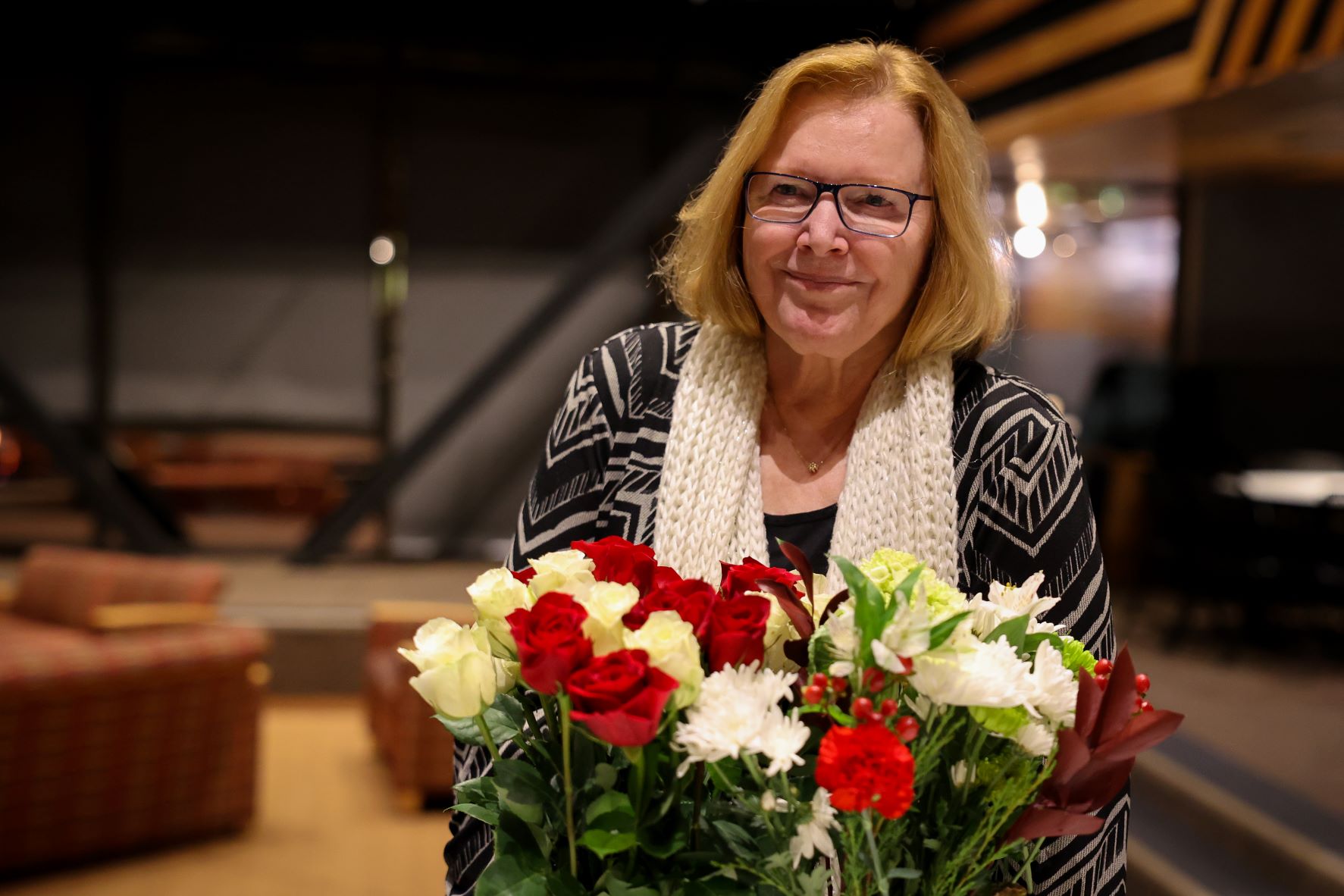 Jill Janke holding flowers and smiling