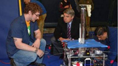 Nick explains the Explorer robot to Eric Evans, Director of the MIT Lincoln Laboratory.
