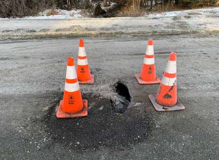 Sinkhole caused by collapsing culvert under Northern Lights Boulevard