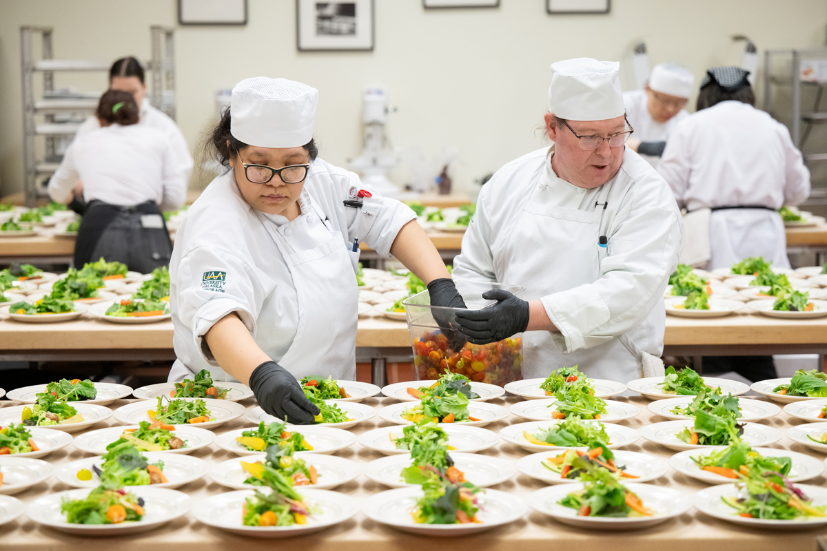 Students prep the salad course during UAA's 2024 Celebrity Chef Invitational.