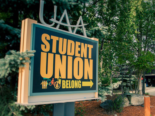 UAA Student Union sign points towards front door.