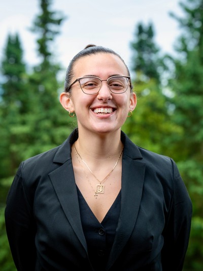 Jakki Padilla, woman with brown hair and glasses smiling