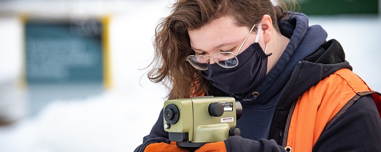 Woman using survey equipment
