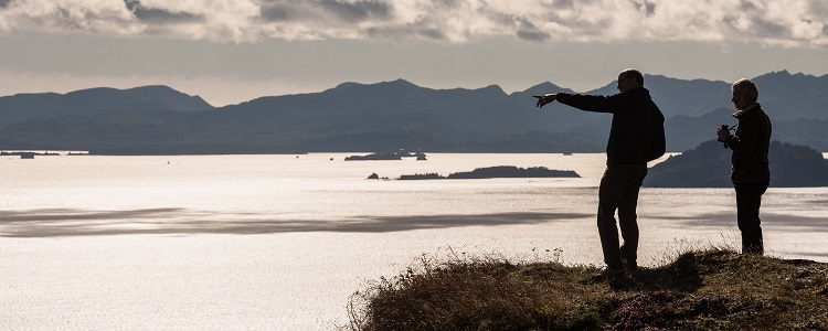 two Directors from Kodiak College looking at ocean from cliff