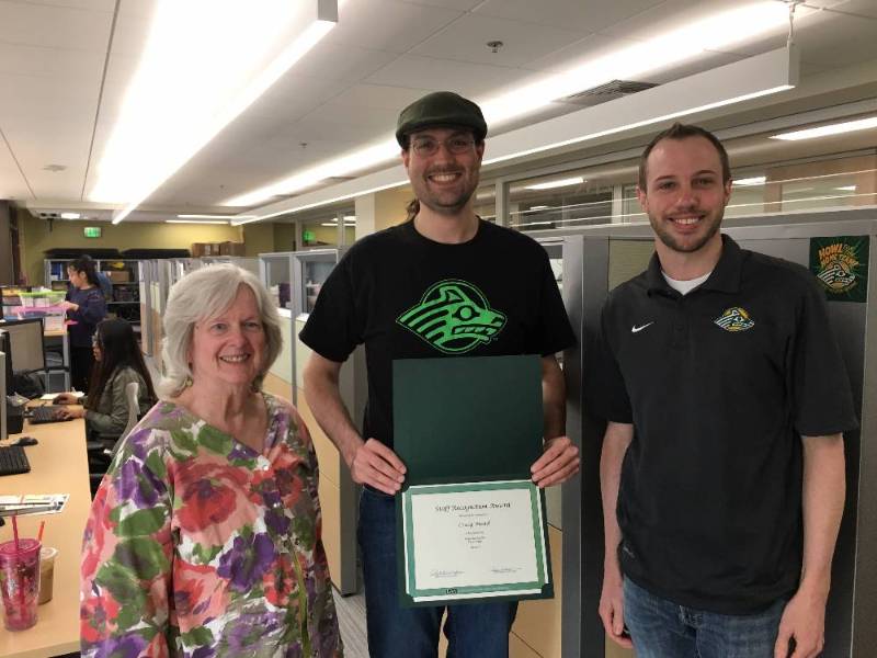 Craig Mead from Office of New Student Recruitment presented with the 2017 April UAA Staff Recognition Award by Liz Winfree and Ryan Hill of Staff Council