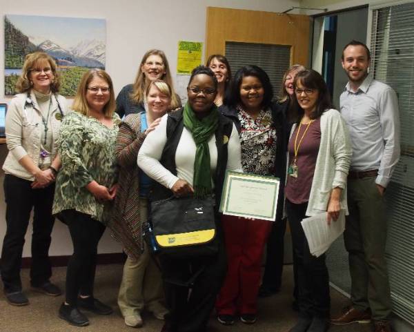 Neicha McCray from Student Health & Counseling Center presented with the 2017 November Staff Recognition Award by Ryan Hill from Staff Council as well as others from Student Health & Counseling Center