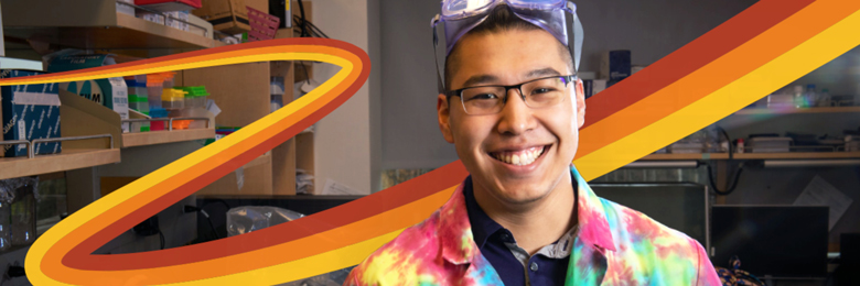 Student smiling in a tie-dye lab coat