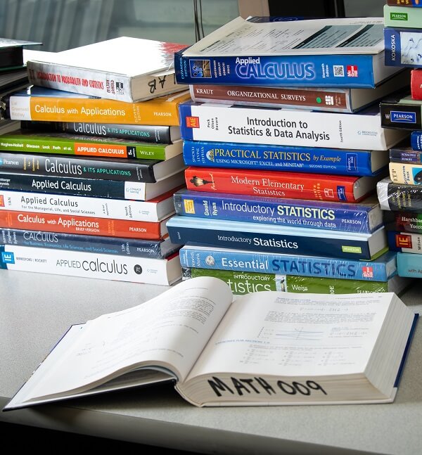Textbooks stacked on a desk 