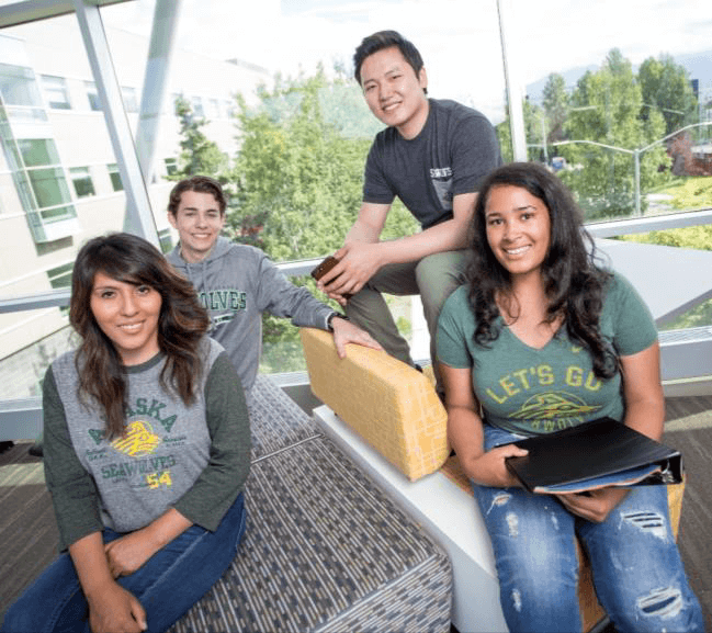 Students pose on couches in the Rasmuson Hall spine.