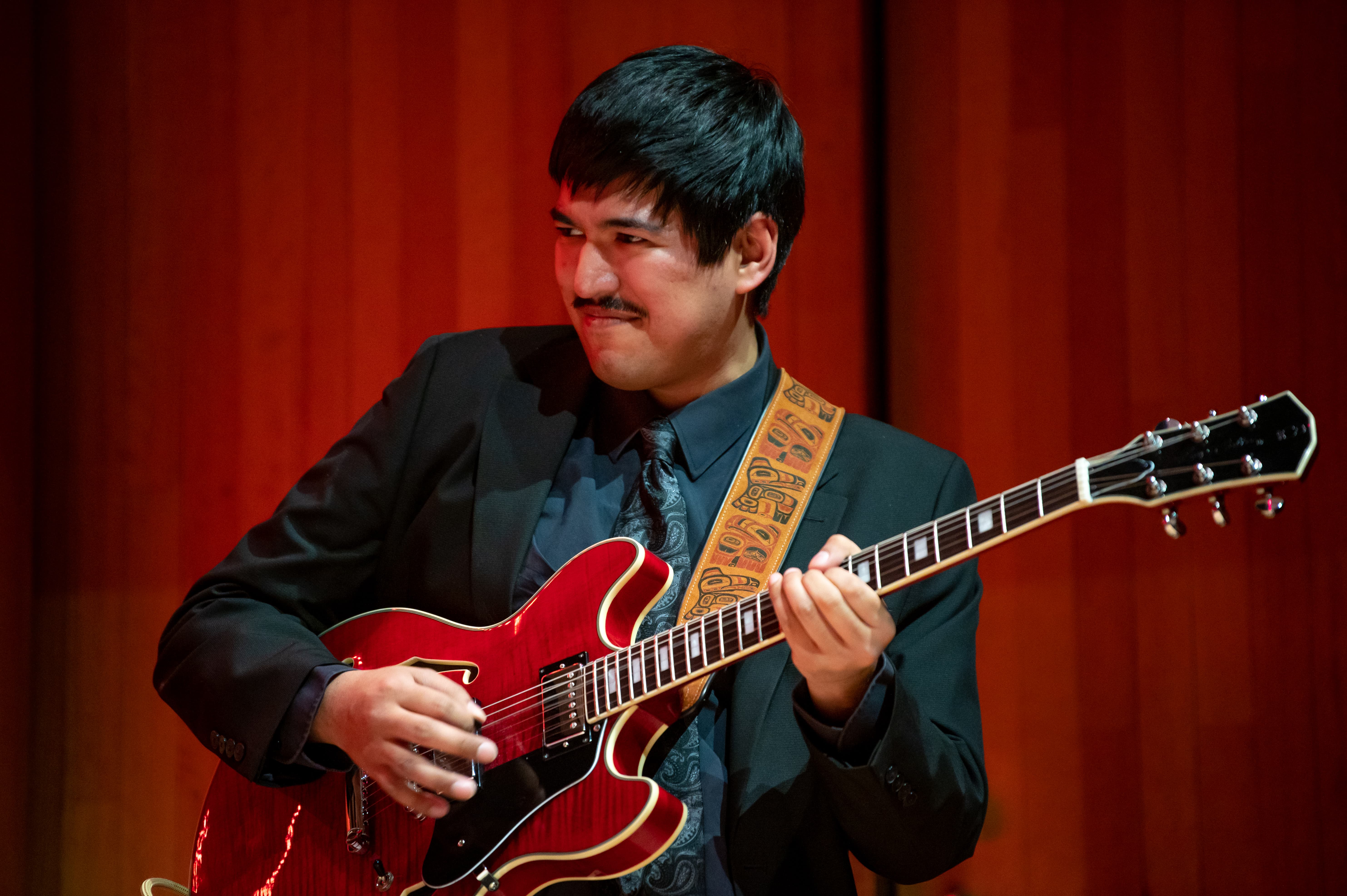 Student playing guitar in the jazz ensemble