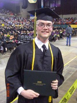 Monty Dickson with diploma in hand at UAA Commencement Ceremony