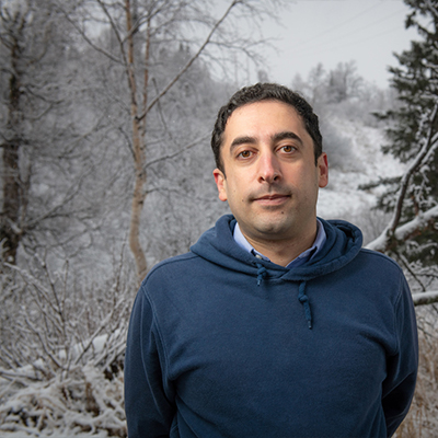 Professor Mohammad Heidari stands in front of frosted trees on Anchorage's Hillside, a potential wildfire hazard.