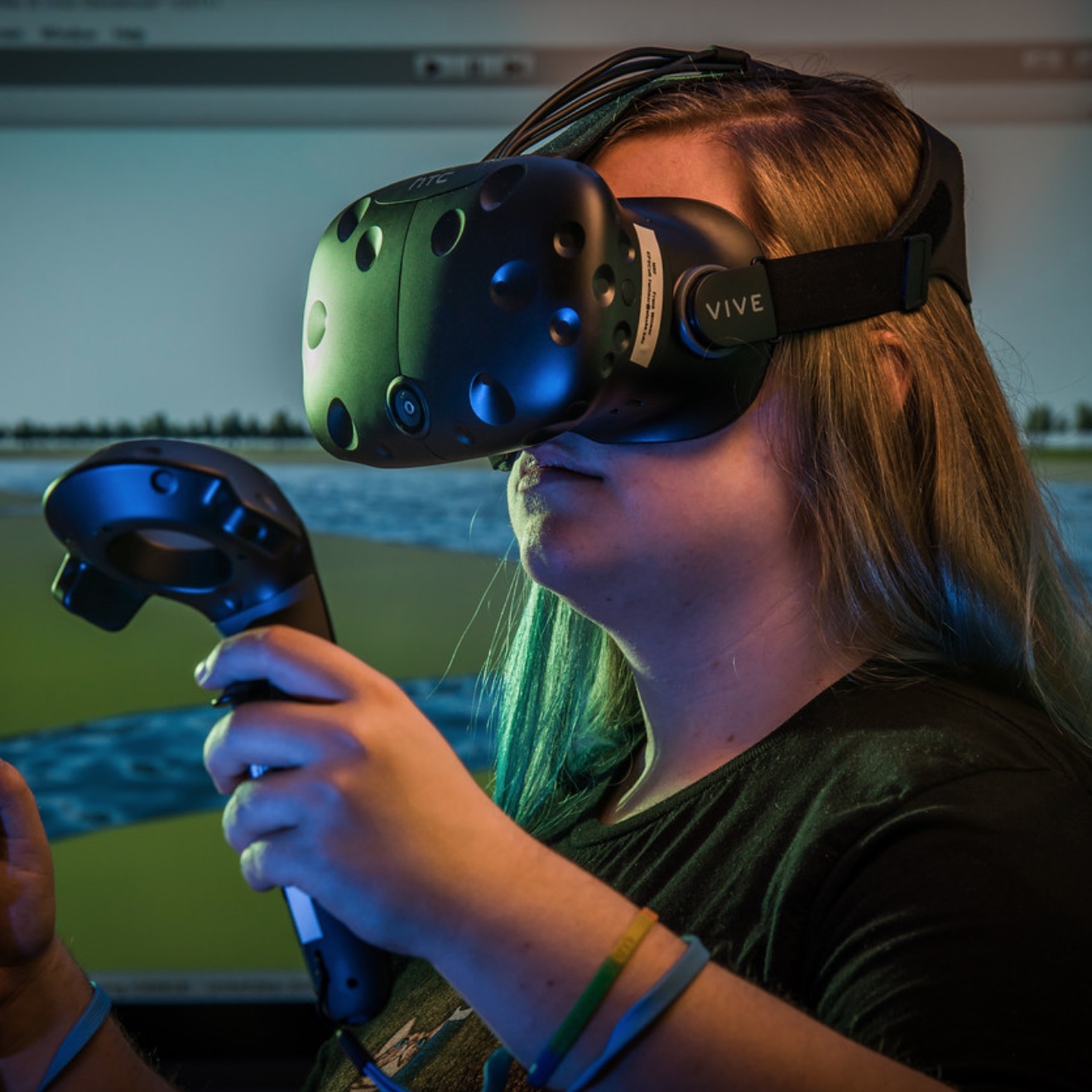 Student testing a virtual reality (VR) headset and hand controller