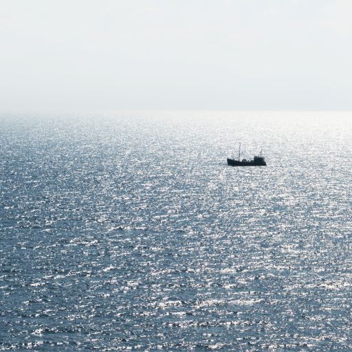 a small fishing boat alone in the ocean