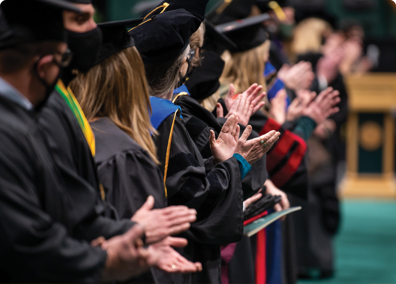 Graduates applauding.