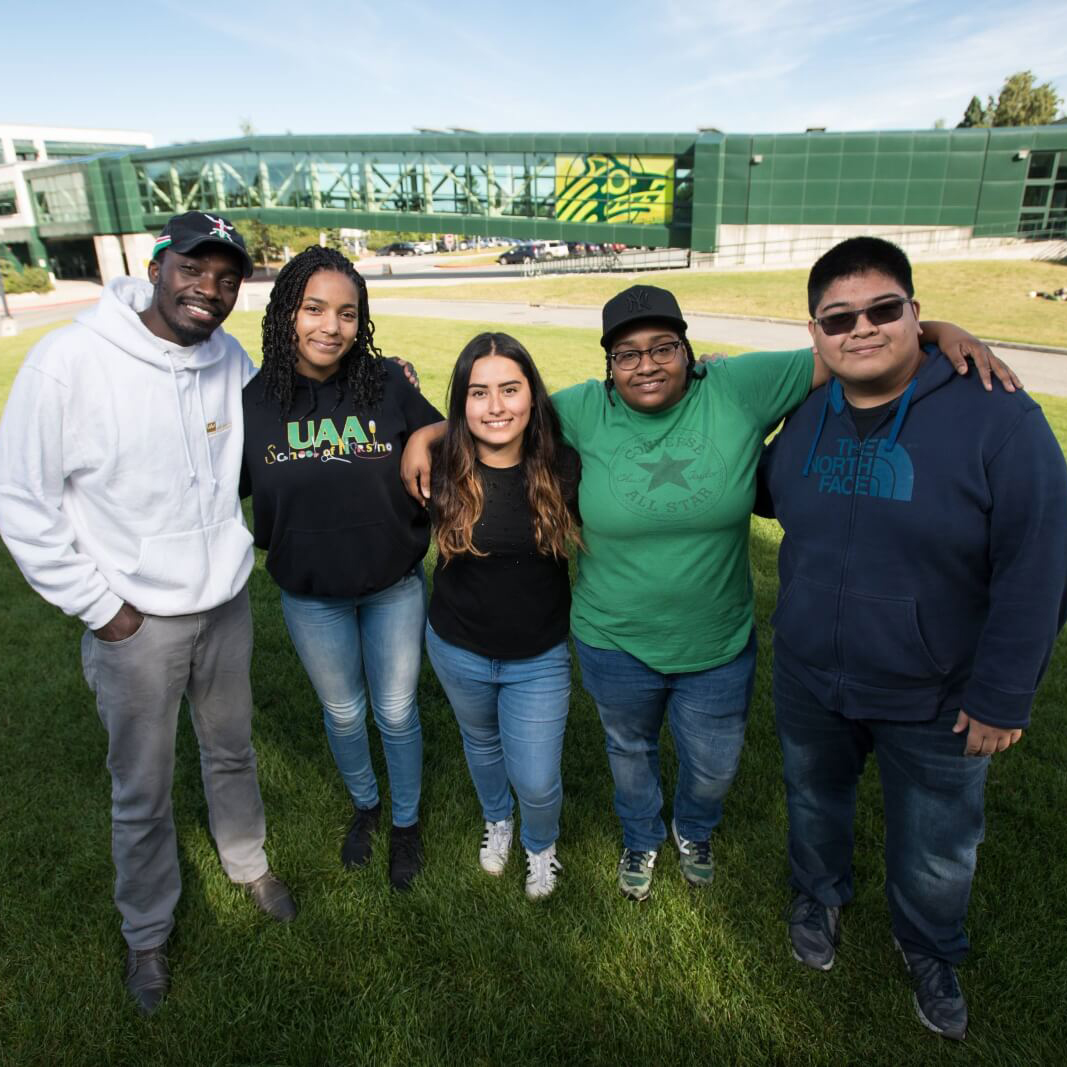 Five UAA students lined up in front of building