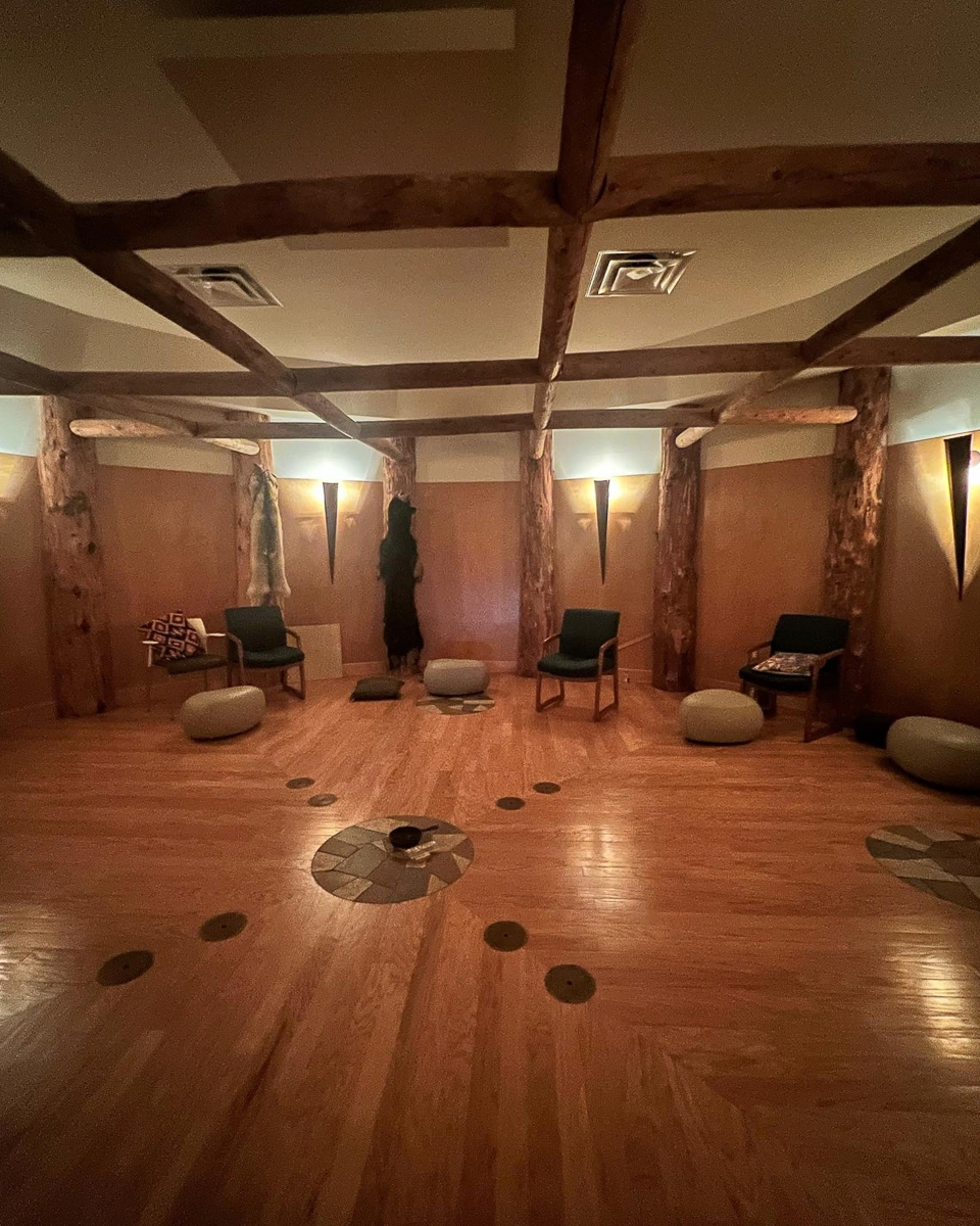 round wooden room with chairs and drums