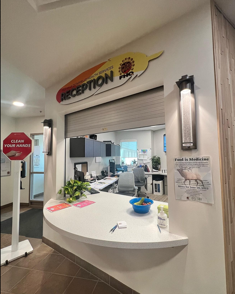 reception desk with sign shaped like feather reading reception