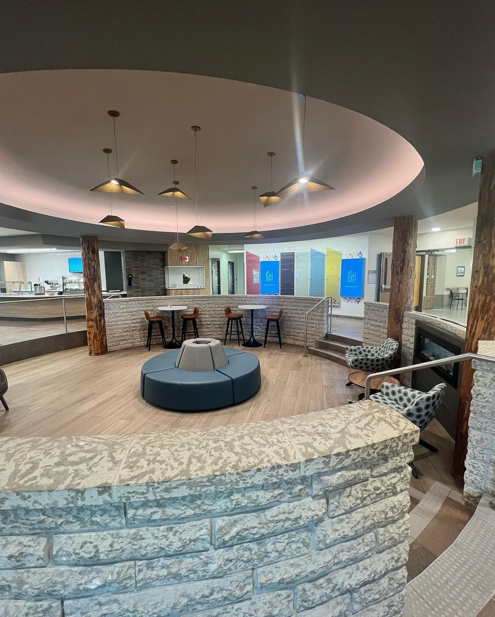 round lobby with fireplace, chairs and table 