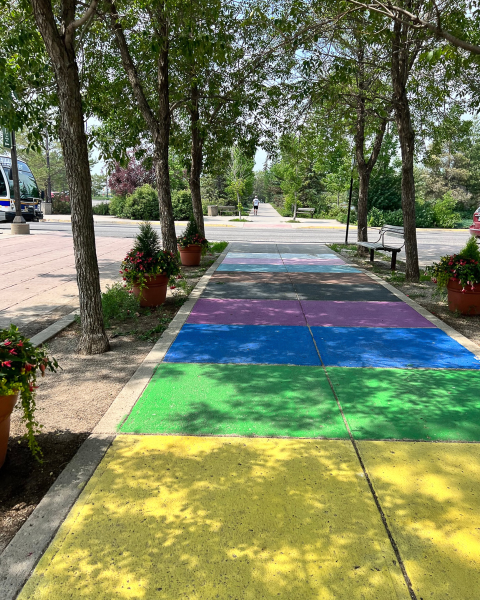 sidewalk painted in rainbow color blocks