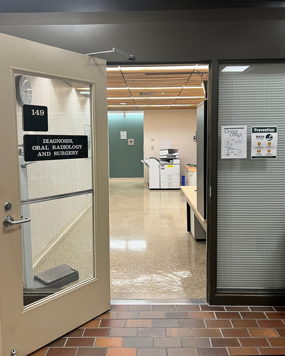 open door with glass window leading to oral surgery center