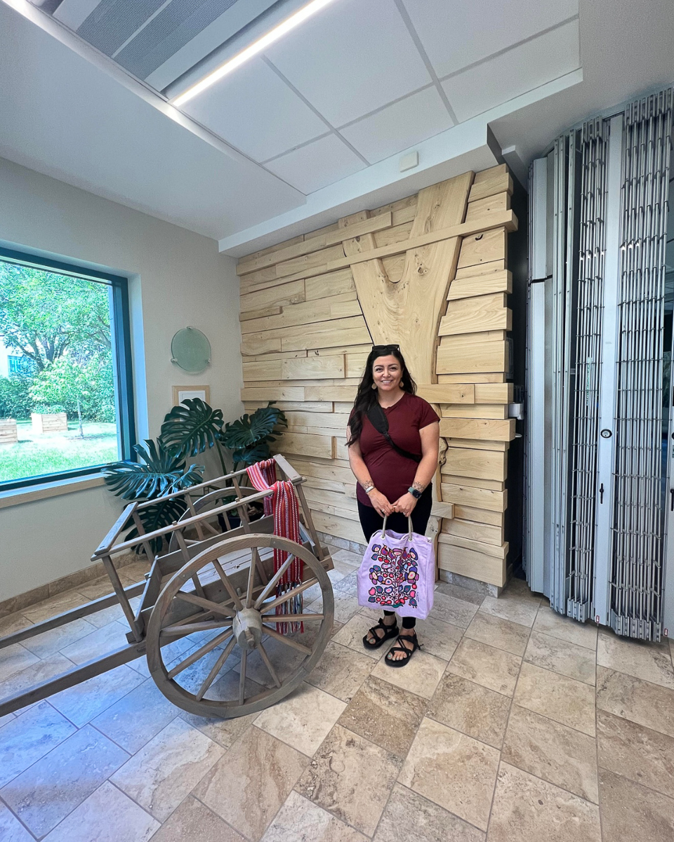 jessica ross holding pink bag next to window