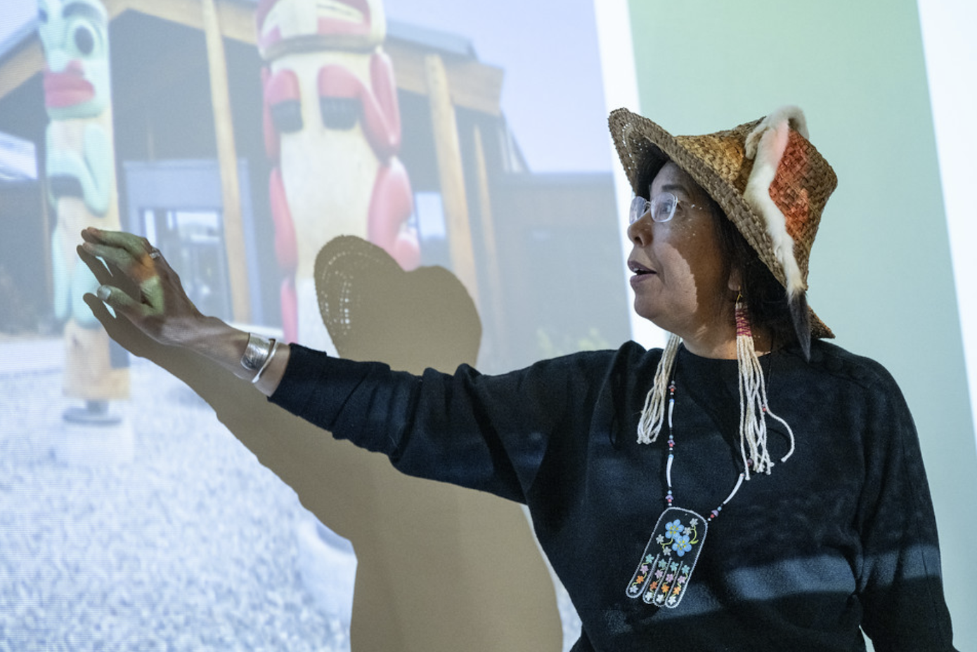 person pointing at projector screen