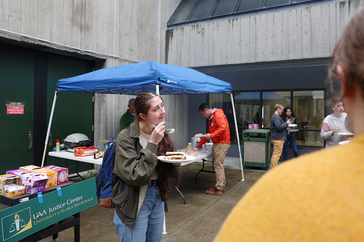 Justice student Elena Konev takes a moment to connect with fellow students during the Return to Campus BBQ event the Justice Center hosted for its returning students on Sept. 8, 2022, at the Professional Studies Building of the University of Alaska Anchorage. (Photo by Ahliil Saitanan/College of Health Dean's Office)