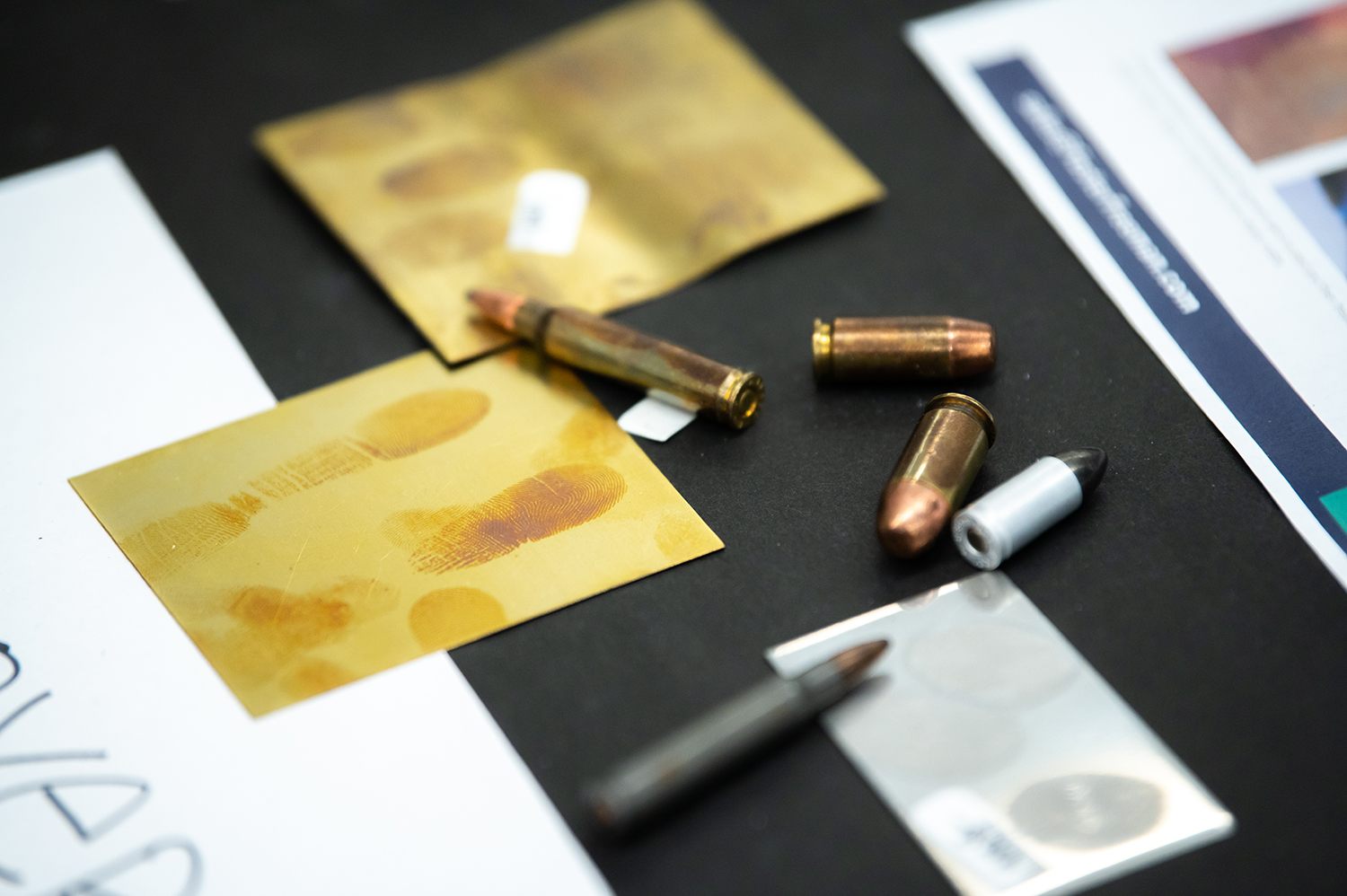 Bullets and finger print slides on table 