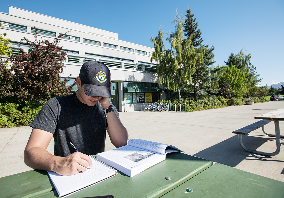 UAA student studies outdoors at one of the tables