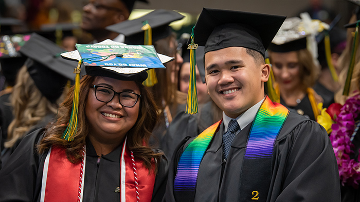 Two BSHS graduates during a UAA commencement ceremony