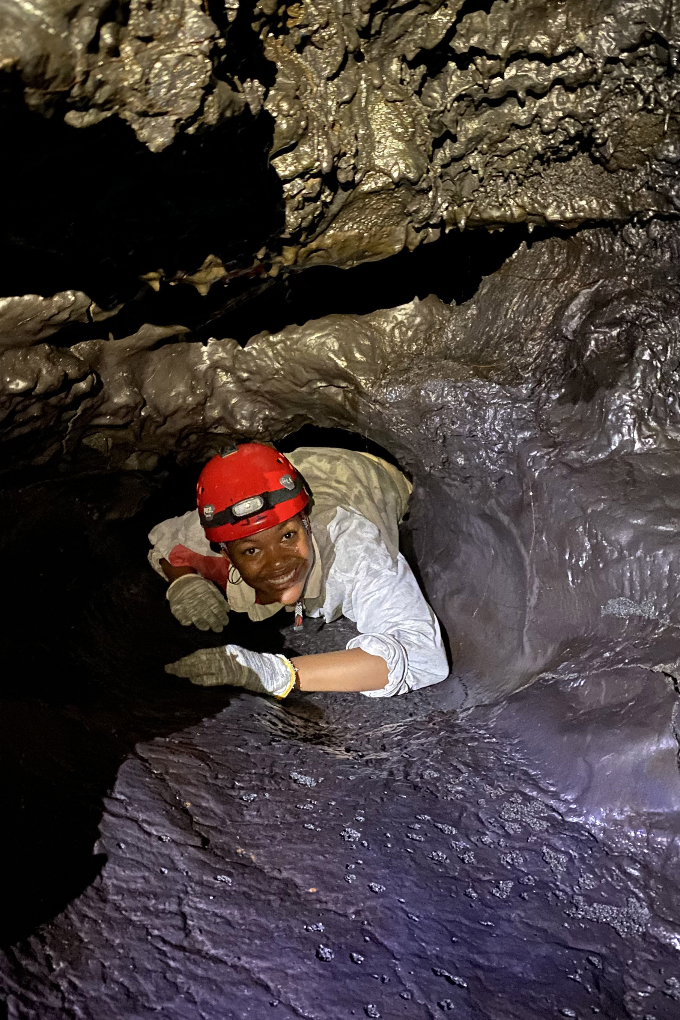 nicole blue wearing helmet crawling in lava cave
