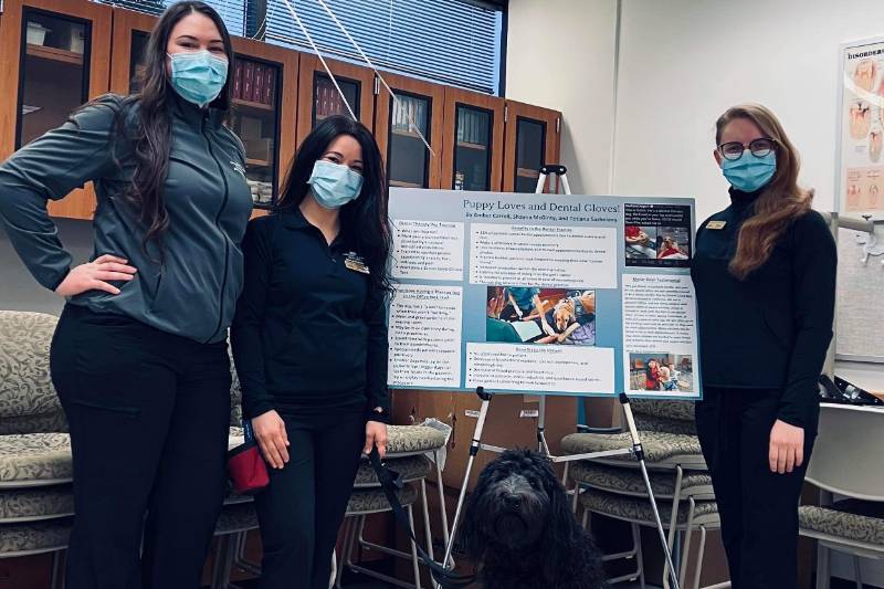 Dental hygiene students presenting research poster