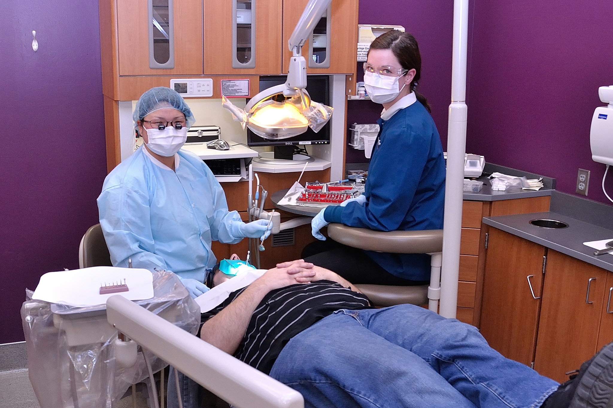 Dental Assistants helping patient