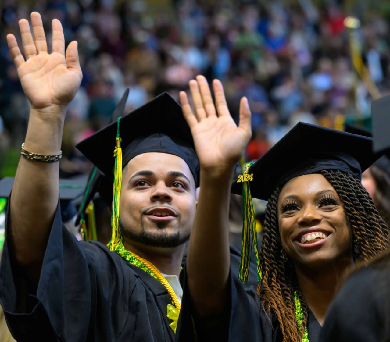 Graduate students waving.
