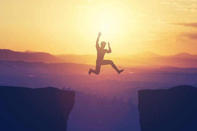 a person jumping over a gap