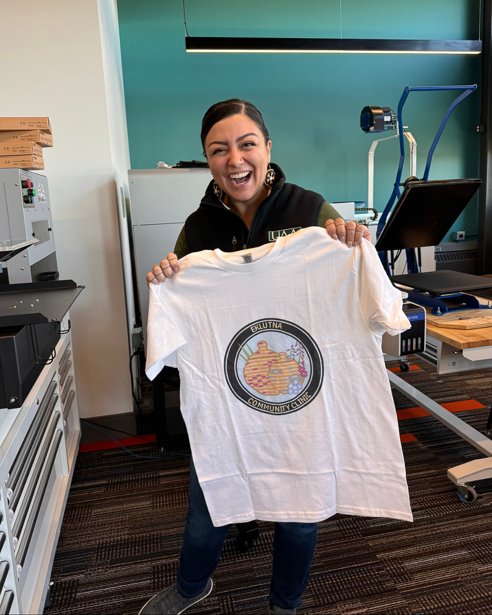 jessica ross silimg and holding eklutna community clinic teeshirt