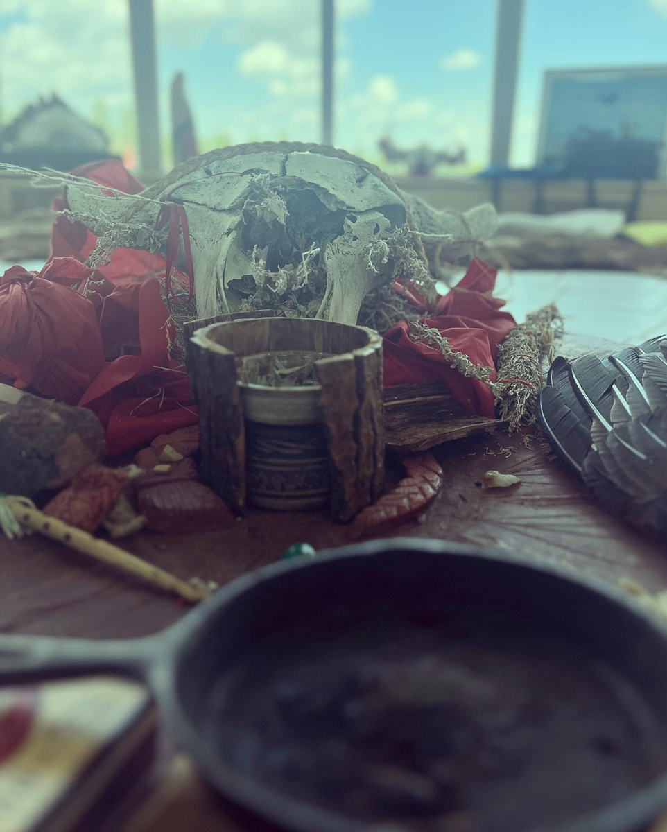 pan, animal scull and red fabric nexgt to herbs inside dish