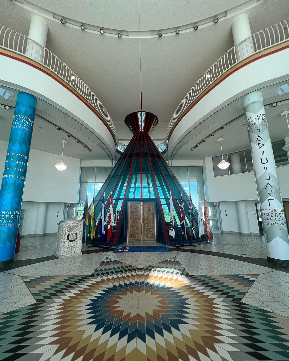marble room with indigenous star pattern on floor and glass teepee shaped entrance