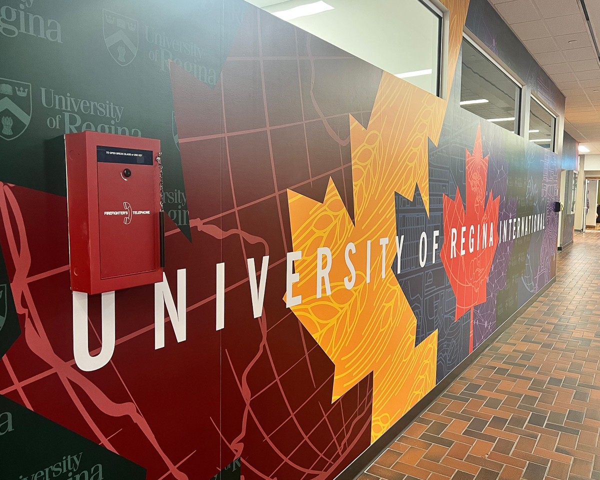 colorful maple leaf wall banner reading "university of regina international"