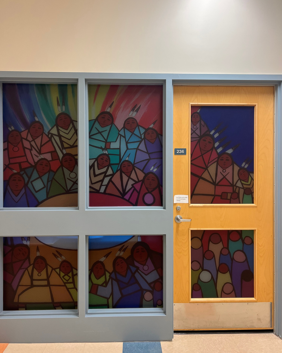 indiginous style artwork of people in circle on frosted glass door