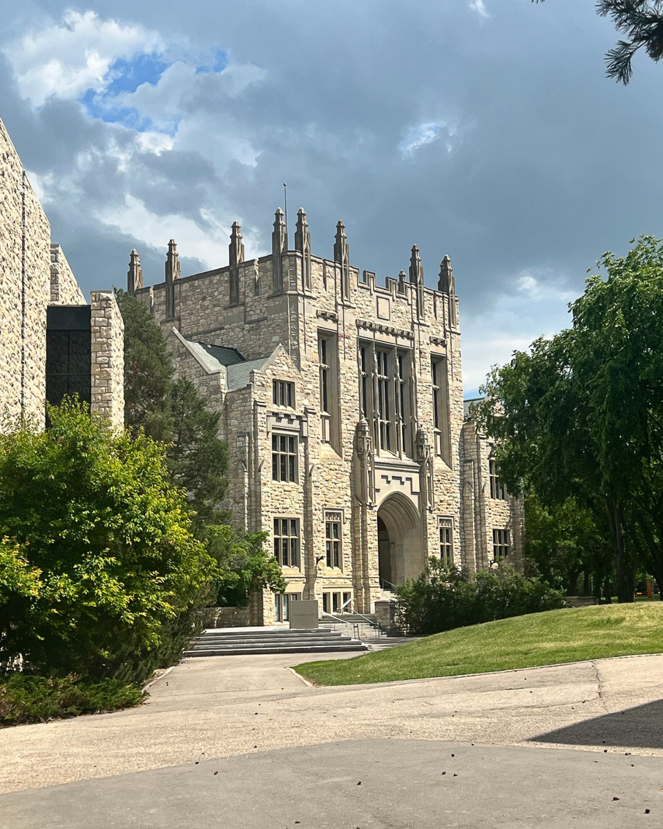 exterior of stone building with castle-like spires and large windows