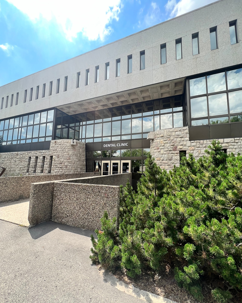 exterior of dental clinic which is a modern, square shaped building with alot of windows