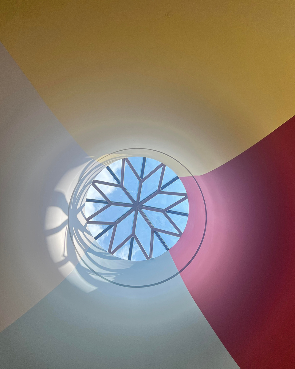 red, blue, white and yellow ceiling with sunroof in shape of star