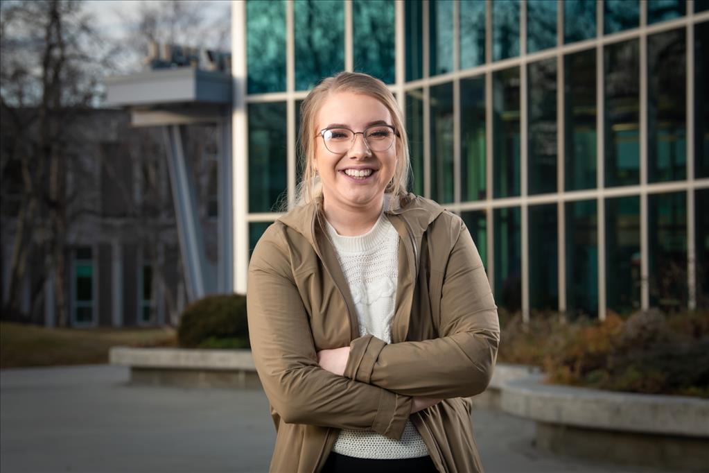 Amanda Magnusen posing in front of campus building